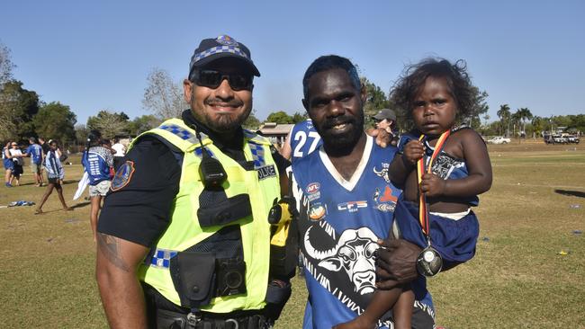 The Buffaloes with police following the win in the Tiwi Island Football League grand final between Tuyu Buffaloes and Pumarali Thunder. Picture: Max Hatzoglou