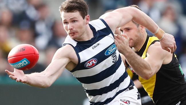Patrick Dangerfield of the Cats is tackled by Trent Cotchin.