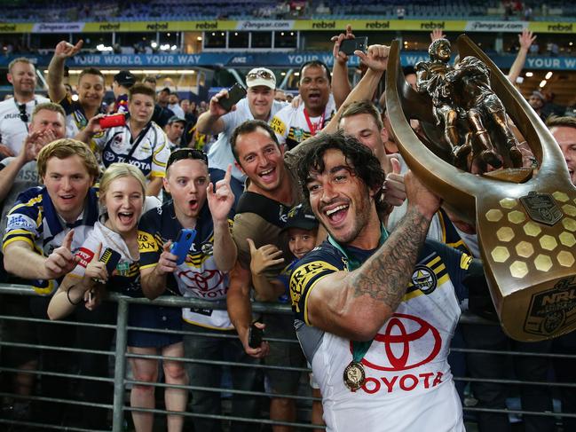 Thurston holds the grand final trophy in front of Cowboys fans after the 2015 NRL Grand Final. Picture: Brett Costello