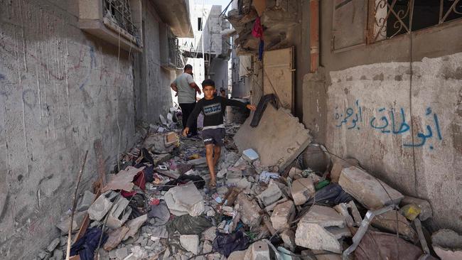 A Palestinian boy walks in an alley following Israel’s bombardment of Nuseirat in the central Gaza Strip on June 18. Picture: AFP