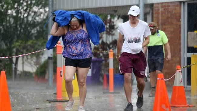 Voters get caught in the rain at Mansfield State School. Pics Tara Croser.