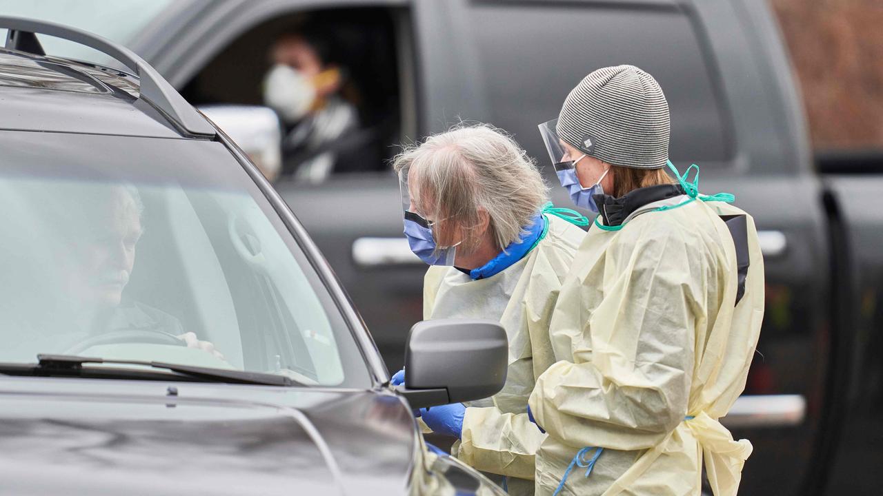 Health care workers speak with patients at a drive-through COVID-19 assessment centre in London, Ontario. Picture: Geoff Robins/AFP