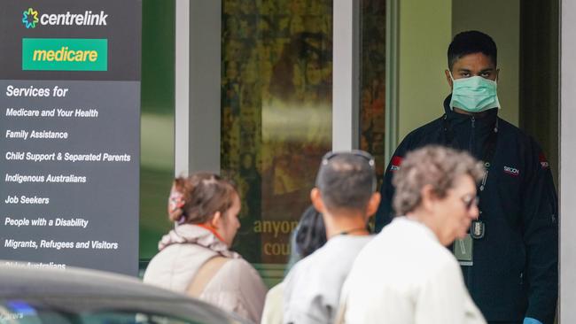 A security guard handles the queues at the Abbotsford Centrelink office. Picture: Scott Barbour (AAP)