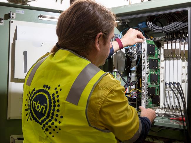 An NBN Co. technician handles hardware in a fiber distribution cabinet during the installation of fiber-to-the-building connections in Sydney, Australia, on Tuesday, Oct. 3, 2017. NBN says it's aiming to increase annual revenue more than five-fold to A$5.4 billion and be cash flow positive in 2021. Photographer: Cole Bennetts/Bloomberg via Getty Images