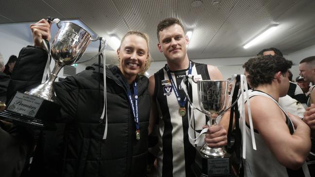 Gabrielle Dwyer and her brother Hayden Dwyer with the A Grade netball and Premier Division football premiership cups. Picture: Valeriu Campan