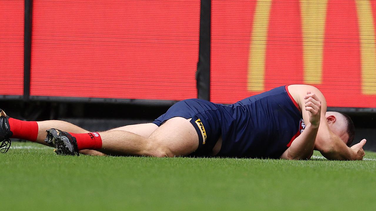 Steven May of the Demons lays on the ground after colliding with Tom Hawkins of the Cats on Sunday Pic: Michael Klein