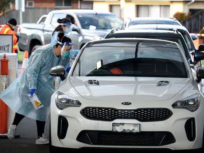 Motorists queue at a pop-up testing clinic at Airport West shopping centre. Picture: Andrew Henshaw