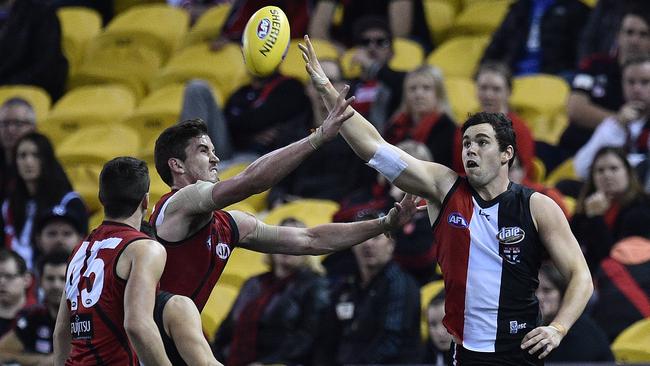 Paddy McCartin of the Saints (right) taps the ball to a teammate during the round 9 win.