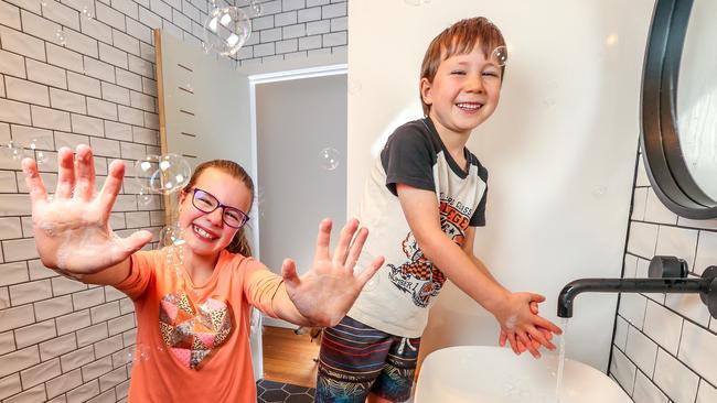 Sylvie Ottinger, 10, and brother Curtis, 7, are regularly told to wash their hands to prevent the spread of germs. Picture: Tim Carrafa