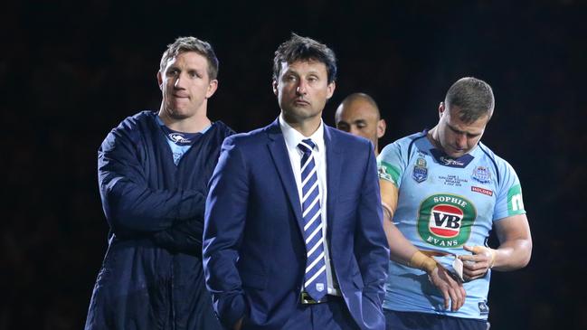 NSW coach Laurie Daley and his players show thier dejection after losing the State of Origin match between Queensland and New South Wales. Pic Darren England.