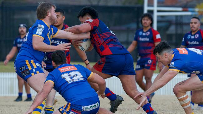 Campbelltown Collegians prop Jaycob Oloaga with a strong run. Picture Thomas Lisson