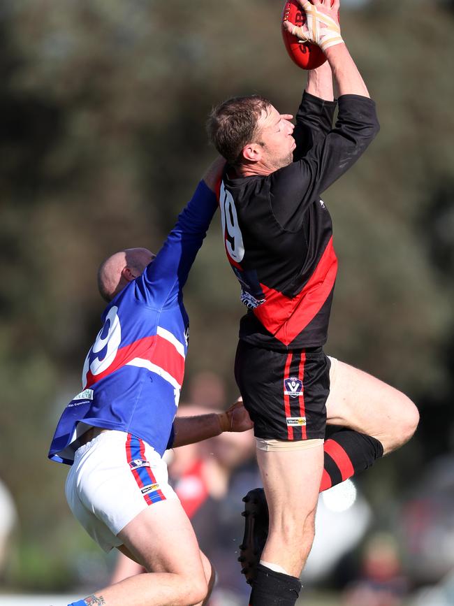 Waaia ruckman Ash Holland marks in front of Strathmerton’s Brock Palmer.