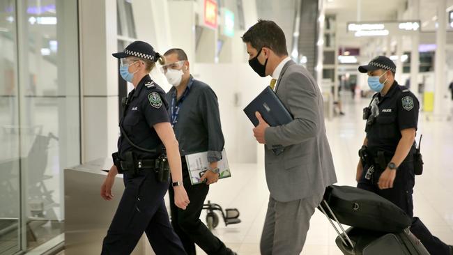 Senator Alex Antic is escorted by police through Adelaide Airport on Thursday night. Picture: Dean Martin