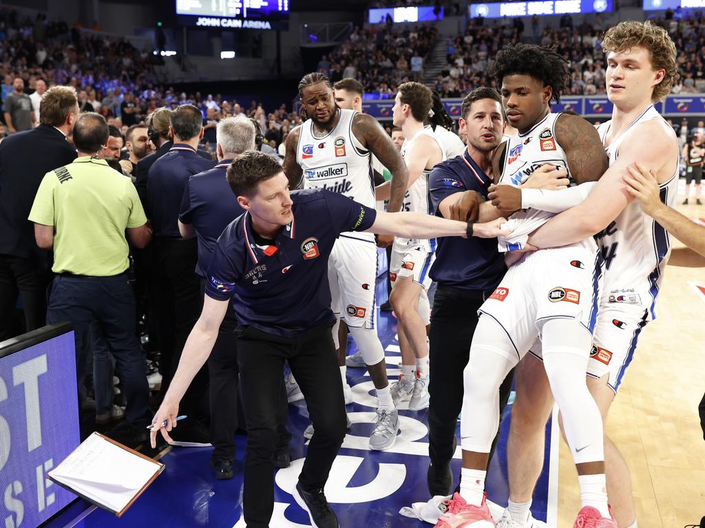 A fired up Kendric Davis is lifted away from the fiery crowd clash. Picture: Getty Images