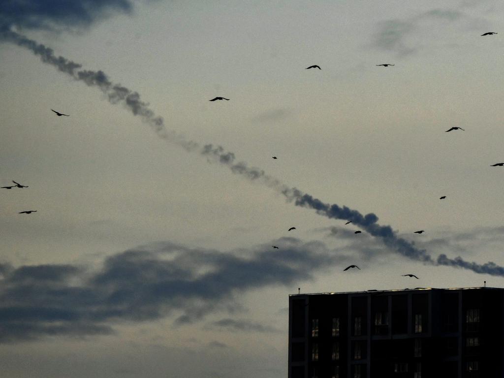 Missiles contrails are seen in the sky over Kyiv on December 29, 2022 amid the Russian invasion of Ukraine. Picture: Sergei Supinsky / AFP.