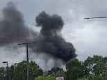 Black smoke can be seen as fire breaks out at Gold Coast holiday park. Picture: Facebook