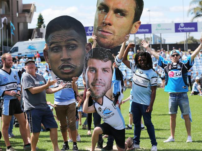 Big heads: Fans parade the cutout faces of their heroes. Picture: Stephen Cooper