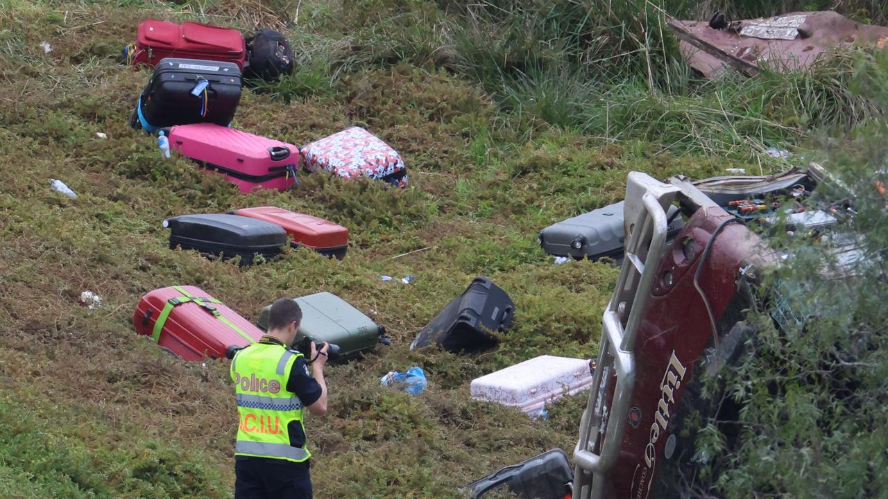 Suitcases sprawled across the ground following the crash. Picture: Brendan Beckett