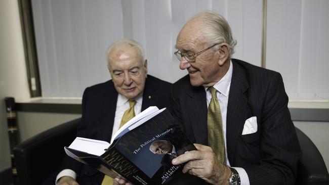 Former Australian PMs Malcolm Fraser, right, and Gough Whitlam reading through Fraser's biography in Sydney in 2010.