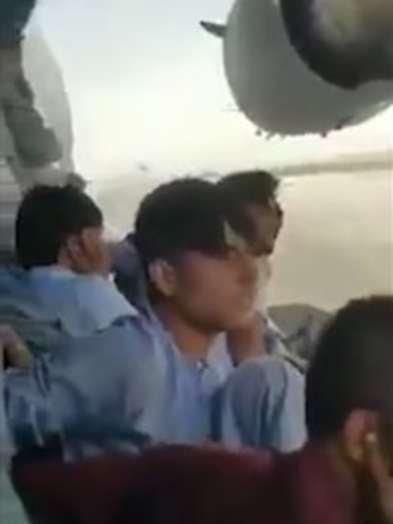 At least a dozen men were seen sitting and holding onto the side of the C-17 as it taxied down the runway at Kabul International Airport. Picture: Twitter