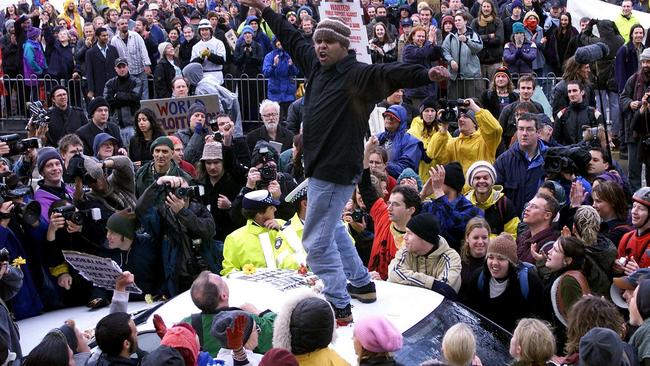 An Aboriginal activist stands on a government car carrying then West Australian premier Richard Court during violent S11 protests against the World Economic Forum (WEF) in Melbourne on September 11, 2000.