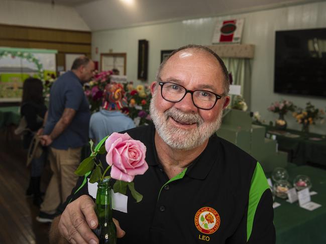 Queensland Rose Society Darling Downs Group member Leo Cooper with the champion of the autumn show grown by Steve Towson of Rosewood, Saturday, May 4, 2024. Picture: Kevin Farmer