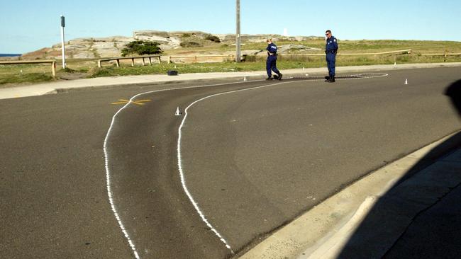 Police scour roadside overlooking cliff in Marine Parade, Maroubra after discovery of blood stain on road before body of underworld figure Anthony (Tony) Gerard Vincent Hines shortly recovered from underwater cave, north of Mistral Point. Picture: Nathan Edwards.