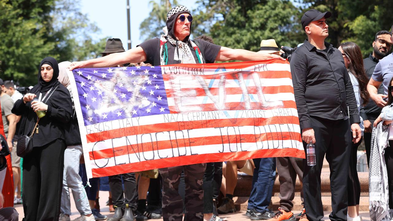 Protesters are waving an array of flags and symbols. Picture: NewsWire / Damian Shaw