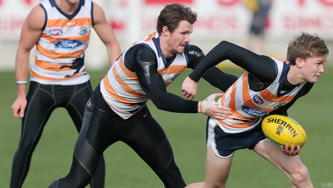 Matthew Hayball getting tackled by Cats superstar Patrick Dangerfield during a Geelong training in 2016. Picture: Mike Dugdale