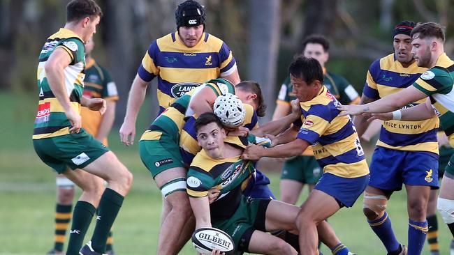 Surfers Paradise scrumhalf James Crisp offloads under pressure from Eagles player Shoma Okubo. Picture: Richard Gosling