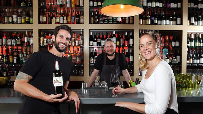 Sumptuous simplicity: Sommelier Louella Mathews at The Wine Library in Woollahra with owners Tim Perlstone and Matt Taylor-Watkins. Picture: Tim Hunter.