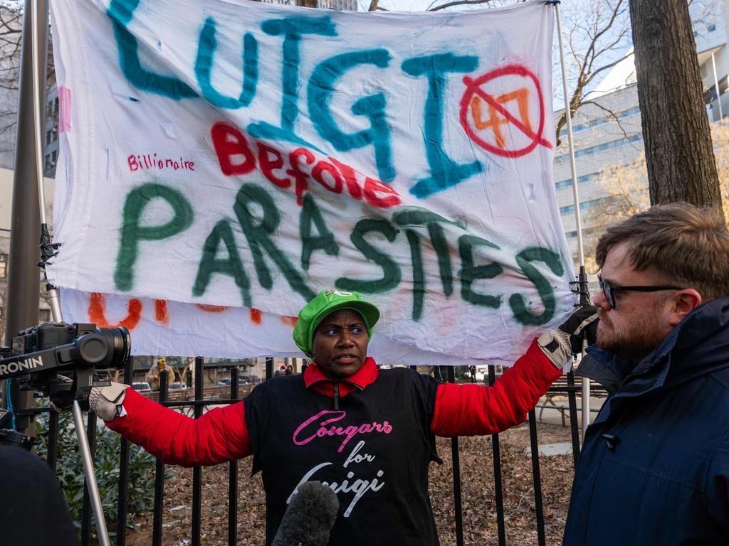 Supporters hold up banners outside Manhattan Criminal Court. Picture: Spencer Platt / Getty via AFP