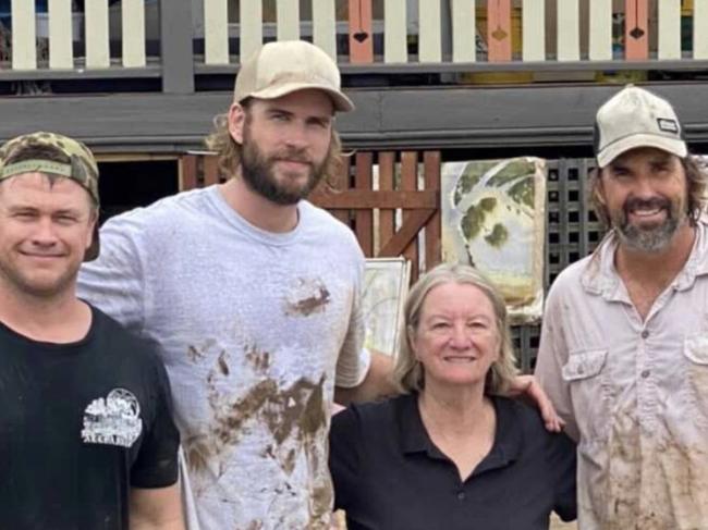 Luke and Liam Hemsworth, brothers of Thor star Chris, were joined by tennis legend Pat Rafter and others in cleaning up a flood-ravaged home in Lismore.