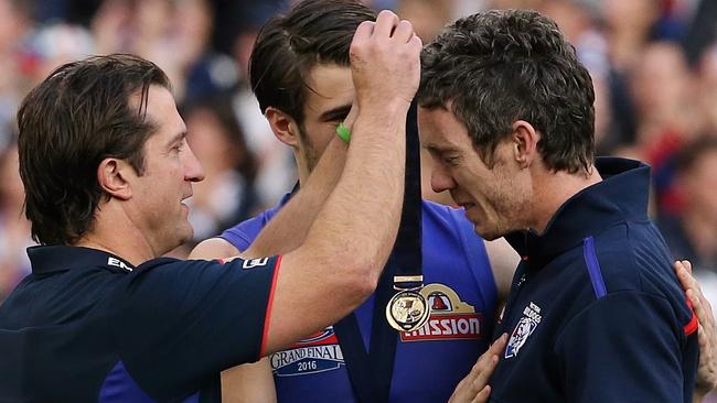 One of the best Grand Final moments of al time. Luke Beveridge puts his premiership medal over Bob Murphy's neck. Picture: Wayne Ludbey