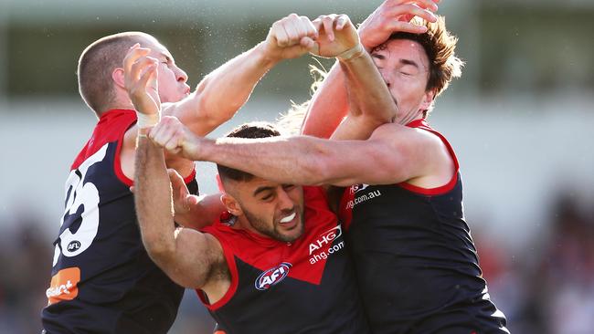 Melbourne trio Tom McDonald, Christian Salem and Michael Hibberd get in each others way going for the ball. Picture: Getty Images