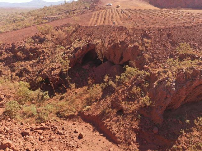 This handout photo taken on May 15, 2020 and released by the PKKP Aboriginal Corporation and recieved by AFP on May 27, 2020 shows Juukan Gorge in Western Australia -- one of the earliest known sites occupied by Aboriginals in Australia. - Anglo-Australian mining giant Rio Tinto has admitted damaging ancient Aboriginal rock shelters in the remote Pilbara region -- blasting near the 46,000-year-old heritage site to expand an iron ore mine. (Photo by Handout / PKKP Aboriginal Corporation / AFP)