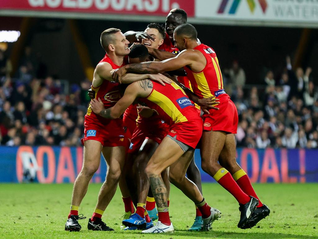 Suns’ team mates celebrate Ace’s first goal in AFL footy. Picture: Russell Freeman/AFL Photos via Getty Images)