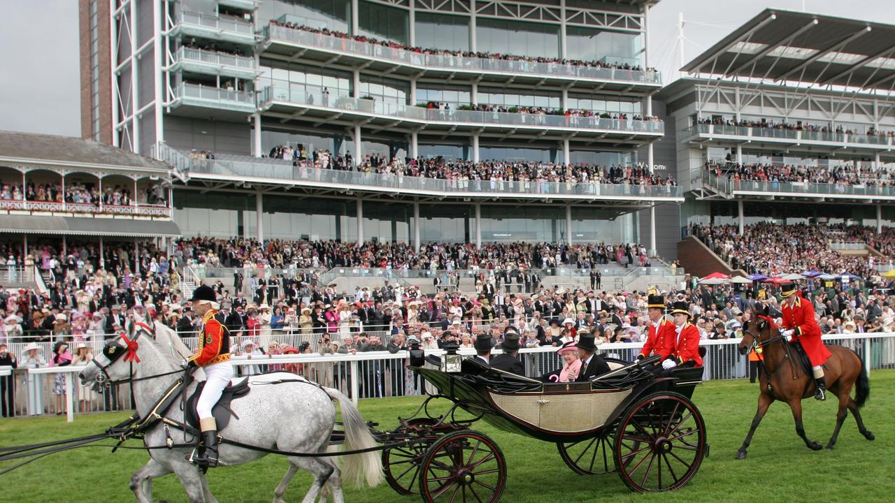 Queen Elizabeth and Prince Phillip arrive in the royal parade prior to the races at Ascot at York in 2005.