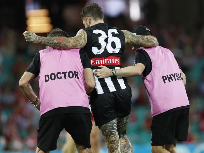 Dane Swan is helped from the ground after seriously injuring his leg and foot. . Picture. Phil Hillyard
