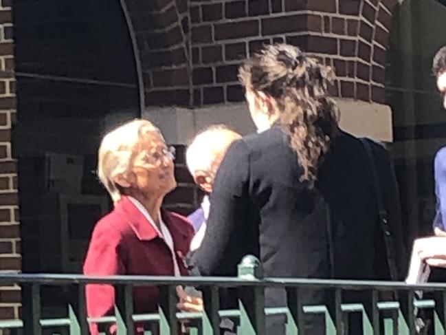 Banned naturopath Marilyn Pauline Bodnar (red coat), 67, of Ellangowan, outside Manly Local Court on Thursday where she was sentenced to an 18-month good behaviour bond. Picture: Jim O'Rourke