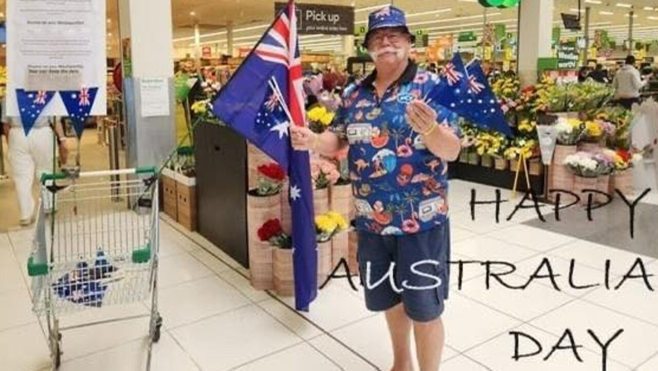 Woolworths Australia Day ‘Legend’ hands out flags outside store The