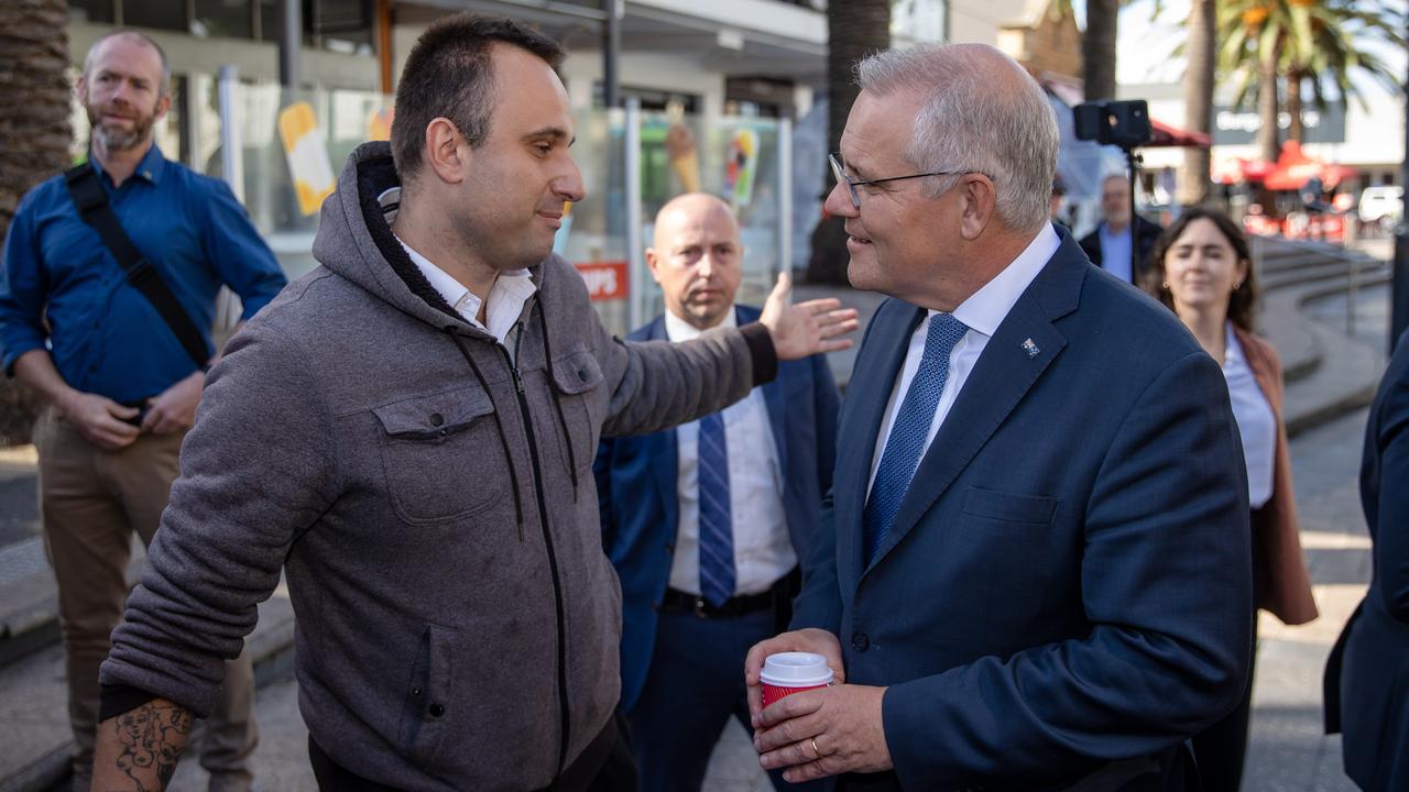 A man asks Scott Morrison about gel blaster guns during his visit to Boothby. Picture: Jason Edwards