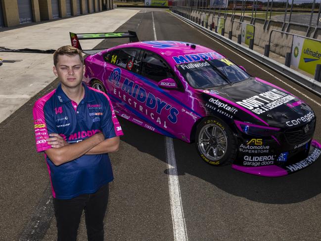 Darwin born and raised Supercars driver Bryce Fullwood pictured with his Brad Jones Racing Holden Commodore before its new Indigenous Round livery was added.