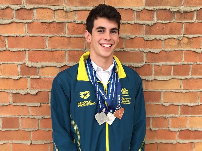 Tom Neill with his world junior swimming championships medals.