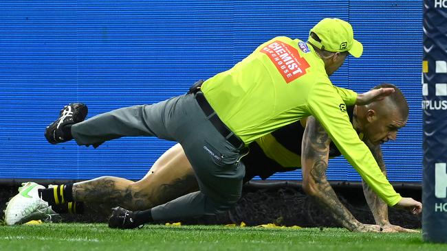 Dustin Martin collides with the goal umpire during the round 9 AFL match between the Richmond Tigers and the Greater Western Sydney Giants.