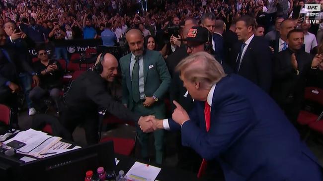 Donald Trump shakes hands with Joe Rogan.