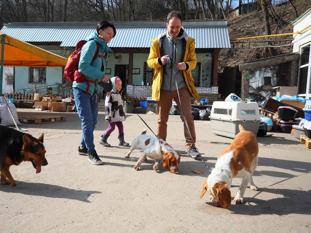 A family visit to the "Home for Rescued Animals" shelter to walk with dogs in the western Ukrainian city of Lviv. Picture: AFP