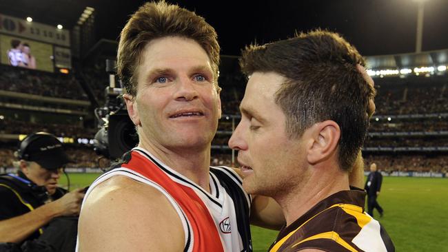 Robert Harvey is embraced by Shane Crawford after the 2008 preliminary final.