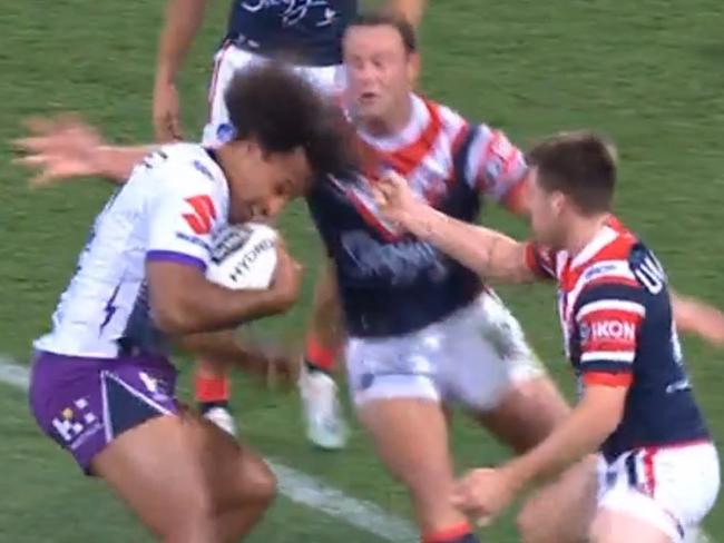 Sydney Roosters' Luke Keary looks to grab a handful of hair from the Storm's Felise Kaufusi in Saturday night's preliminary final at the SCG. Supplied 28/09/19