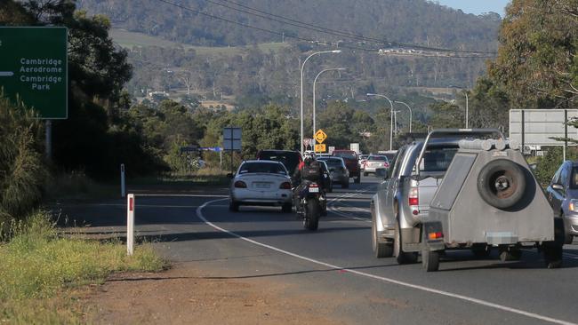 Traffic inbound to Hobart at the airport roundabout slowly banks up in morning traffic